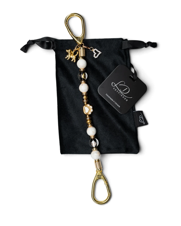 LD Keyfinder Furever Love beaded keychain with white seashell beads, gold paw charm, and heart pendant in velvet bag.