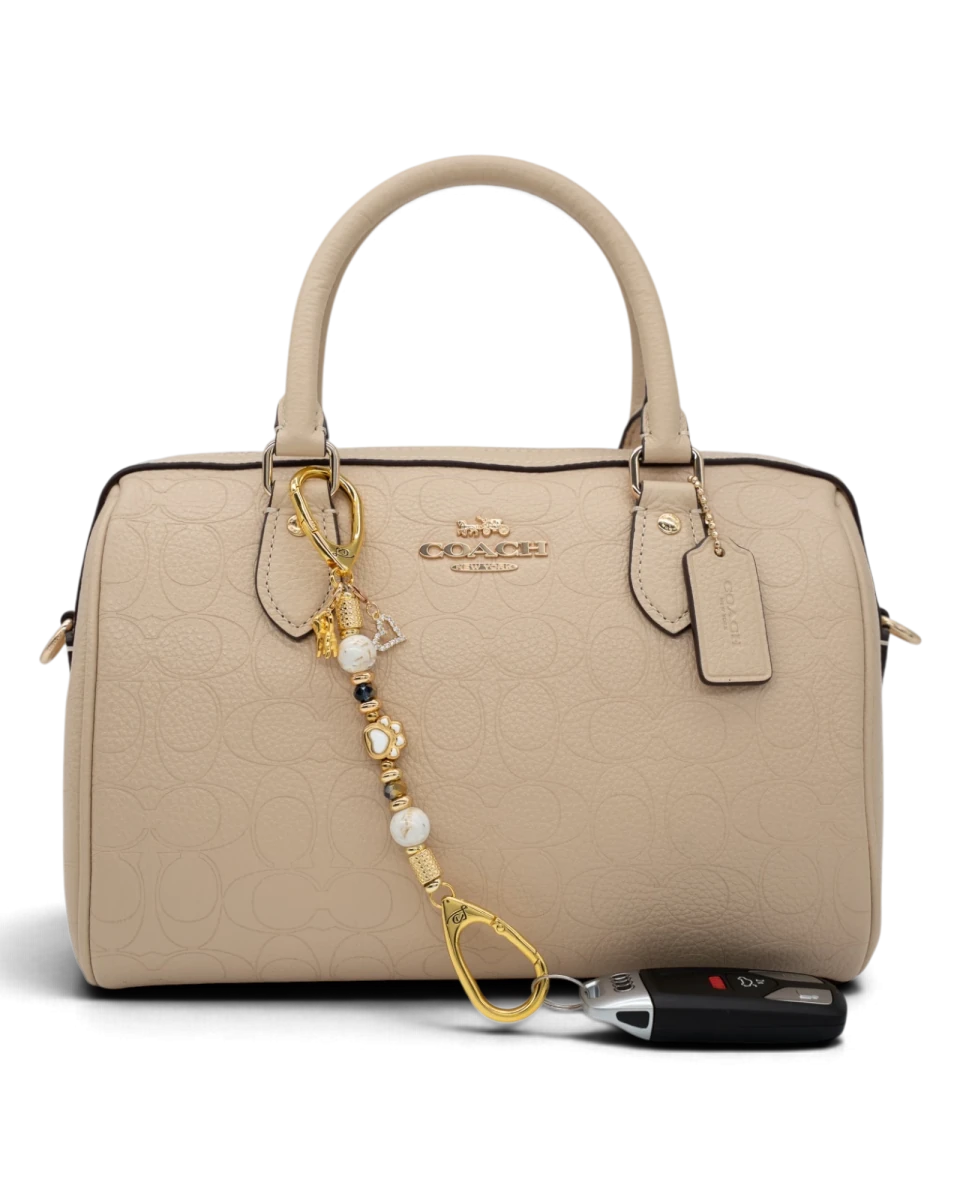 LD Keyfinder Furever Love-Mini charm with white seashell and gold beads, dog paw, heart, and dog charms on a handbag
