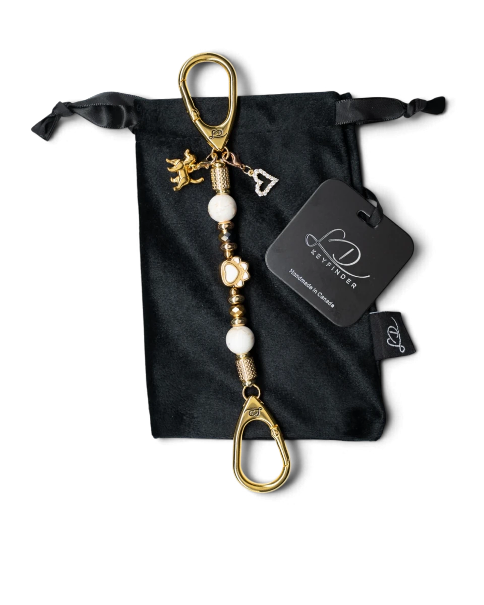 LD Keyfinder Furever Love-Mini keychain with white seashell beads, gold paw charm, and heart charm on velvet bag.