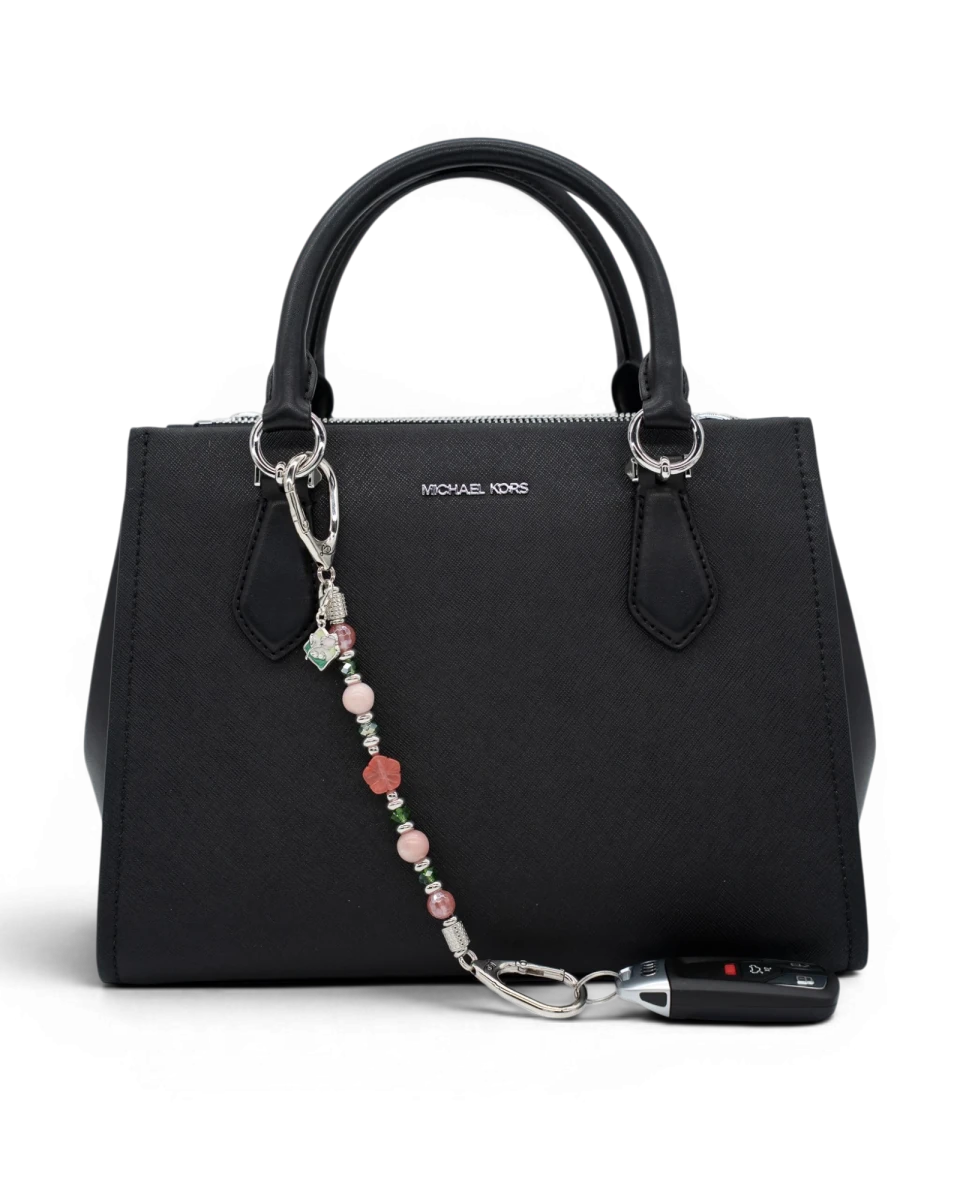 LD Keyfinder Garden Bliss beaded accessory with cherry quartz and pink opal attached to a black handbag