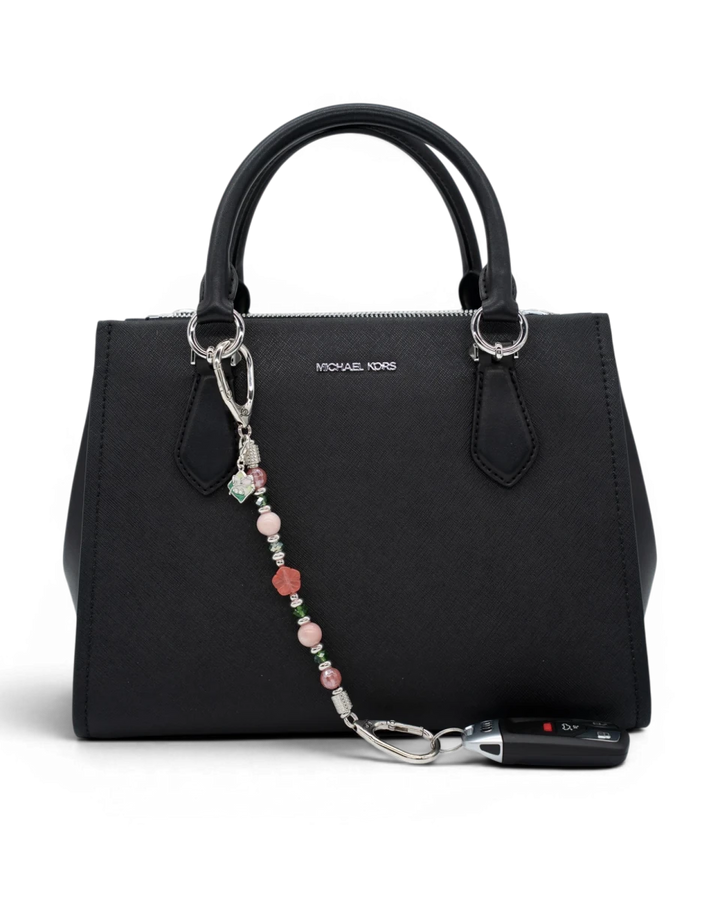LD Keyfinder Garden Bliss beaded accessory with cherry quartz and pink opal attached to a black handbag