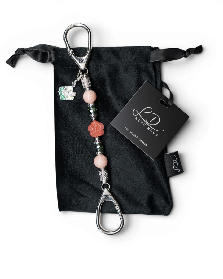 LD Keyfinder Garden Bliss-Mini featuring pink opal beads, cherry quartz flower, and enamel bouquet charm on velvet bag
