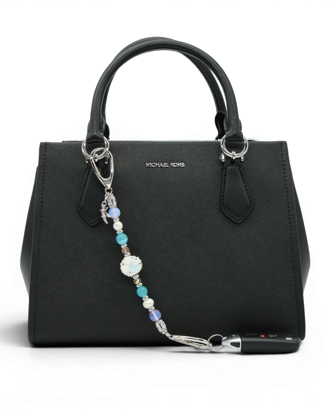 LD Keyfinder Garden Serenade beaded accessory with pearls, opalite, and hummingbird charm attached to a black handbag.