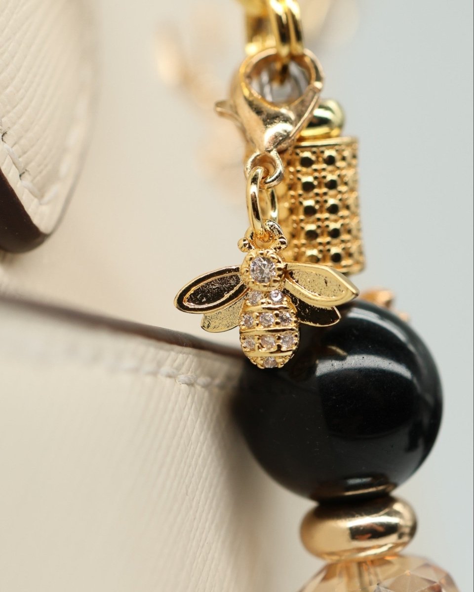 LD Keyfinder Gilded Bee charm with gold-plated bumblebee, black obsidian bead, and crystal accents.