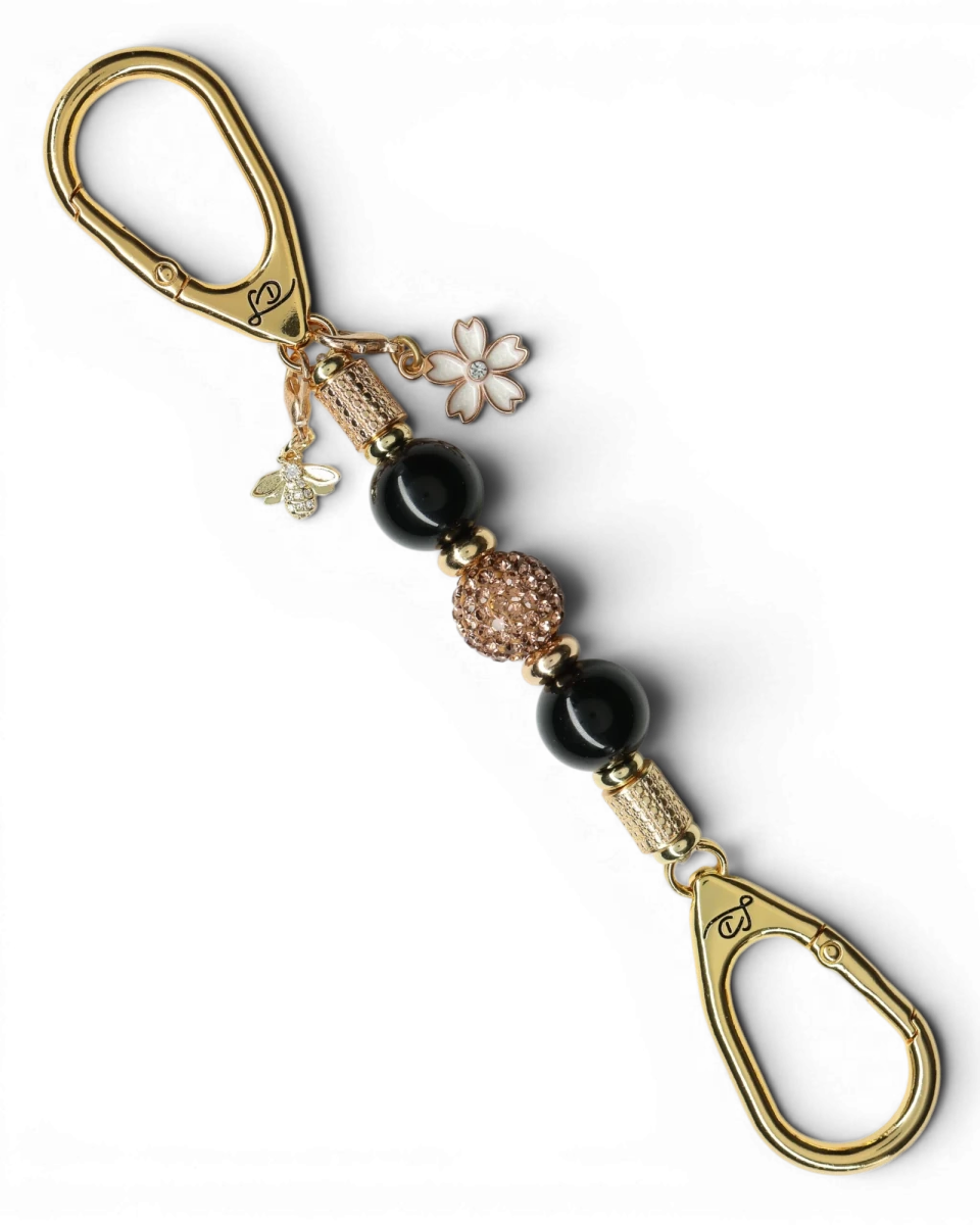 LD Keyfinder Gilded Bee Mini keychain with black obsidian beads, crystal-embellished center bead, flower and bee charms, gold accents.