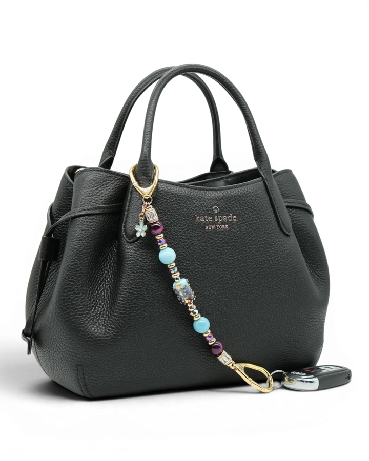 LD Keyfinder Gilded Fantasy keychain with sky blue, topaz, purple, and gold beads, a blue flower charm, and a rhinestone accent.