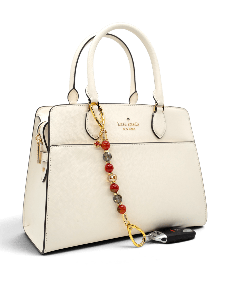 LD Keyfinder Golden Autumn beaded key finder with agate and crystal charms attached to a white handbag
