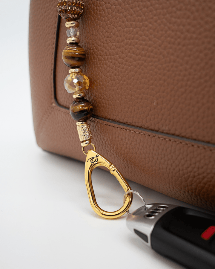 LD Keyfinder Golden Equinox beaded keychain featuring Tiger Eye, gold-plated accents, and a sun and moon charm.