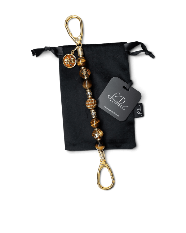 LD Keyfinder Golden Equinox beaded keyfinder with Tiger Eye, crystal beads, and a gold sun and moon charm on velvet bag