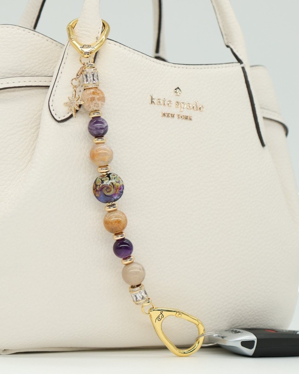 LD Keyfinder Golden Nebula charm with purple, gold, and tan beads, star charm, and gold clasp.