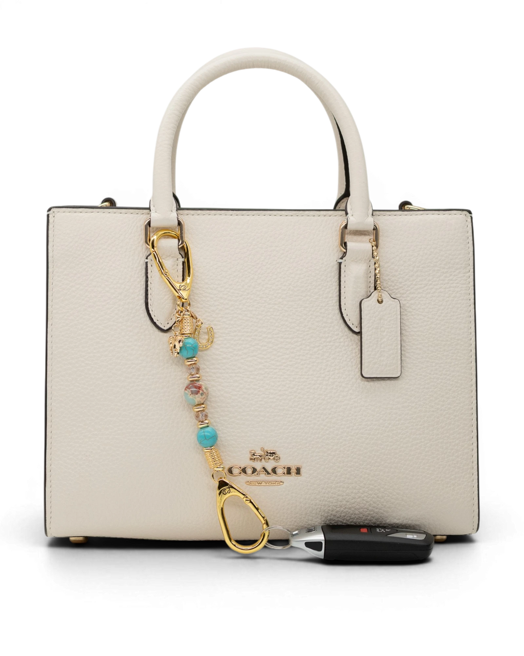 LD Keyfinder Golden Prairie-Mini beaded charm with turquoise and gold accents attached to a white leather handbag