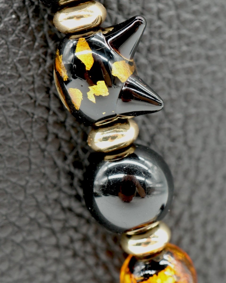 LD Keyfinder Golden Purrs beaded accessory featuring a black and gold foil cat head lampwork bead and obsidian beads.