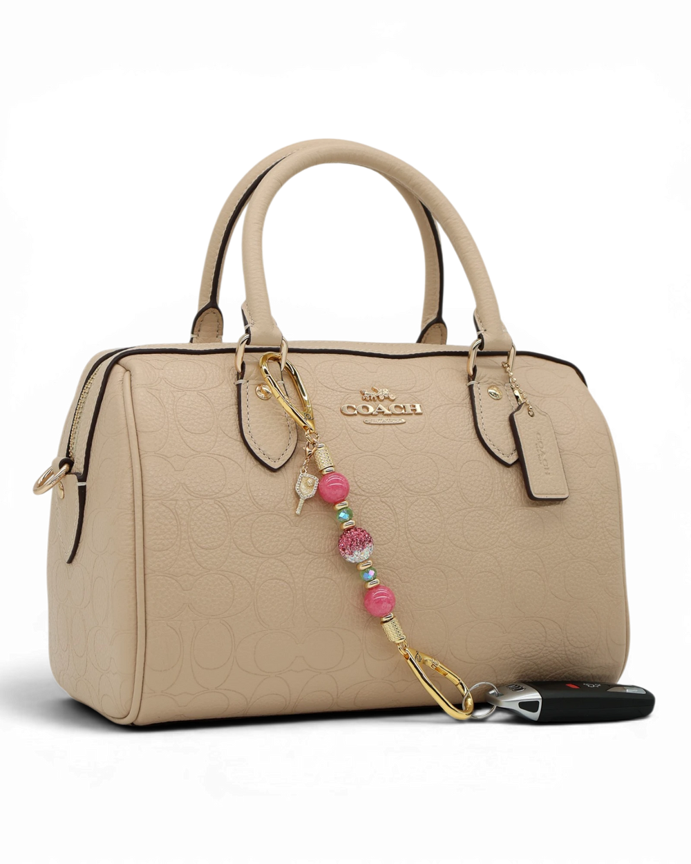 LD Keyfinder Golden Rally-Mini with pink jade, lime glass, Austrian crystal, and pickleball paddle charm on a handbag.