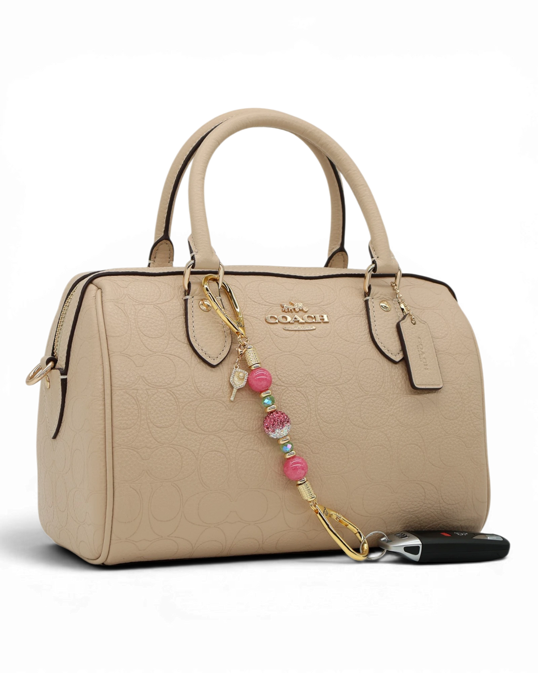 LD Keyfinder Golden Rally-Mini with pink jade, lime glass, Austrian crystal, and pickleball paddle charm on a handbag.