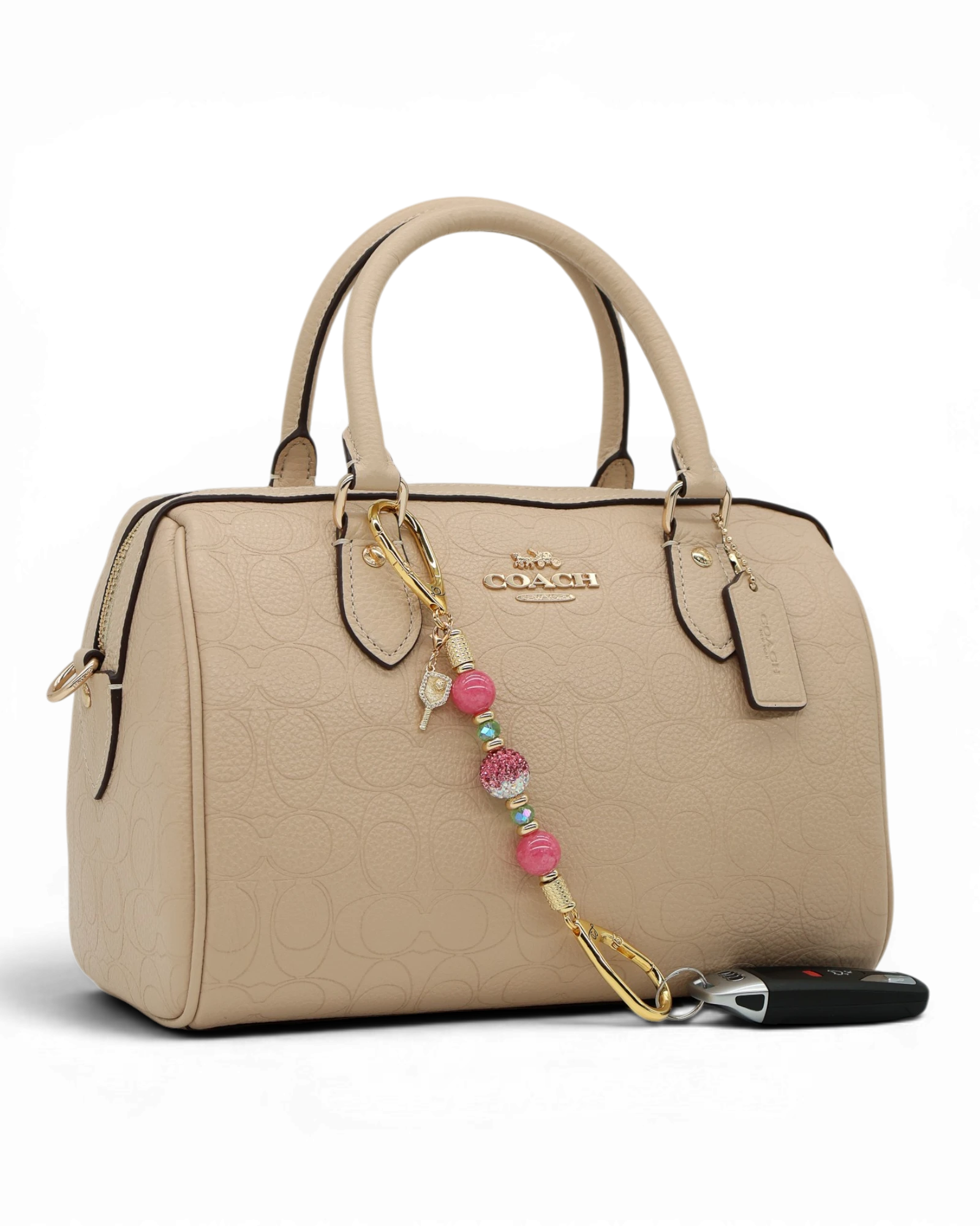 LD Keyfinder Golden Rally-Mini with pink jade, lime glass, Austrian crystal, and pickleball paddle charm on a handbag.