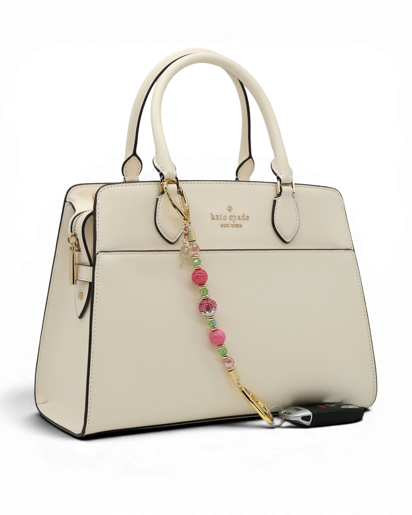 LD Keyfinder Golden Rally beaded keychain with pink quartz, lime glass, and a pickleball paddle charm on a handbag.