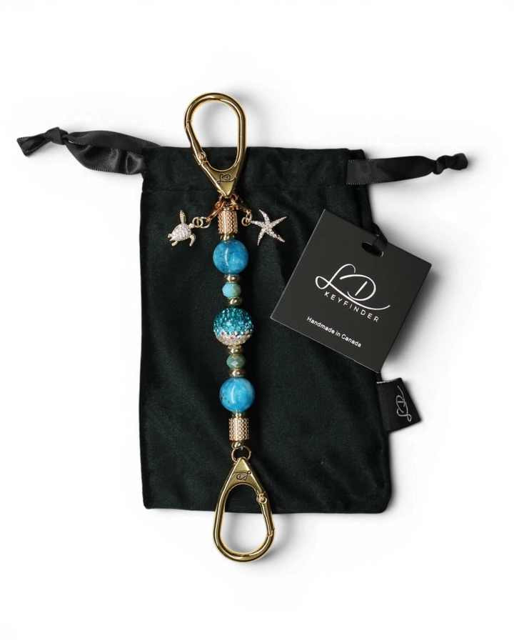 LD Keyfinder Golden Reef Mini keychain with aqua hemimorphite beads, crystal center, starfish & turtle charms, 18k gold plating.