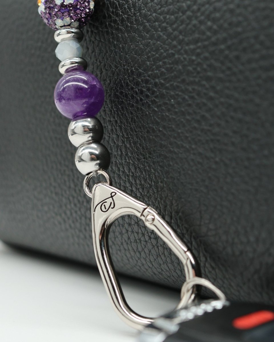 LD Keyfinder Hummingbird Dream Mini keychain with amethyst, crystal daisy bead, and silver charm attached to a car key.