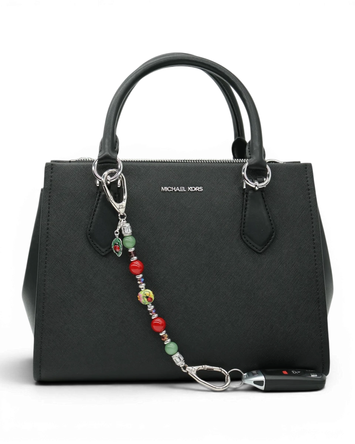 LD Keyfinder Ladybug Love accessory with artisan glass, aventurine, and shell pearl beads attached to a black handbag.