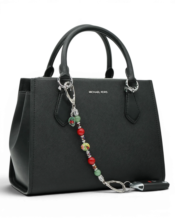 LD Keyfinder Ladybug Love beaded keychain with artisan glass, aventurine, and red shell pearls on a black handbag.