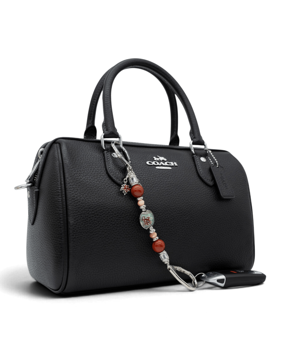 LD Keyfinder Petite Maple Majesty accessory with red jasper and artisan glass beads attached to a black leather handbag