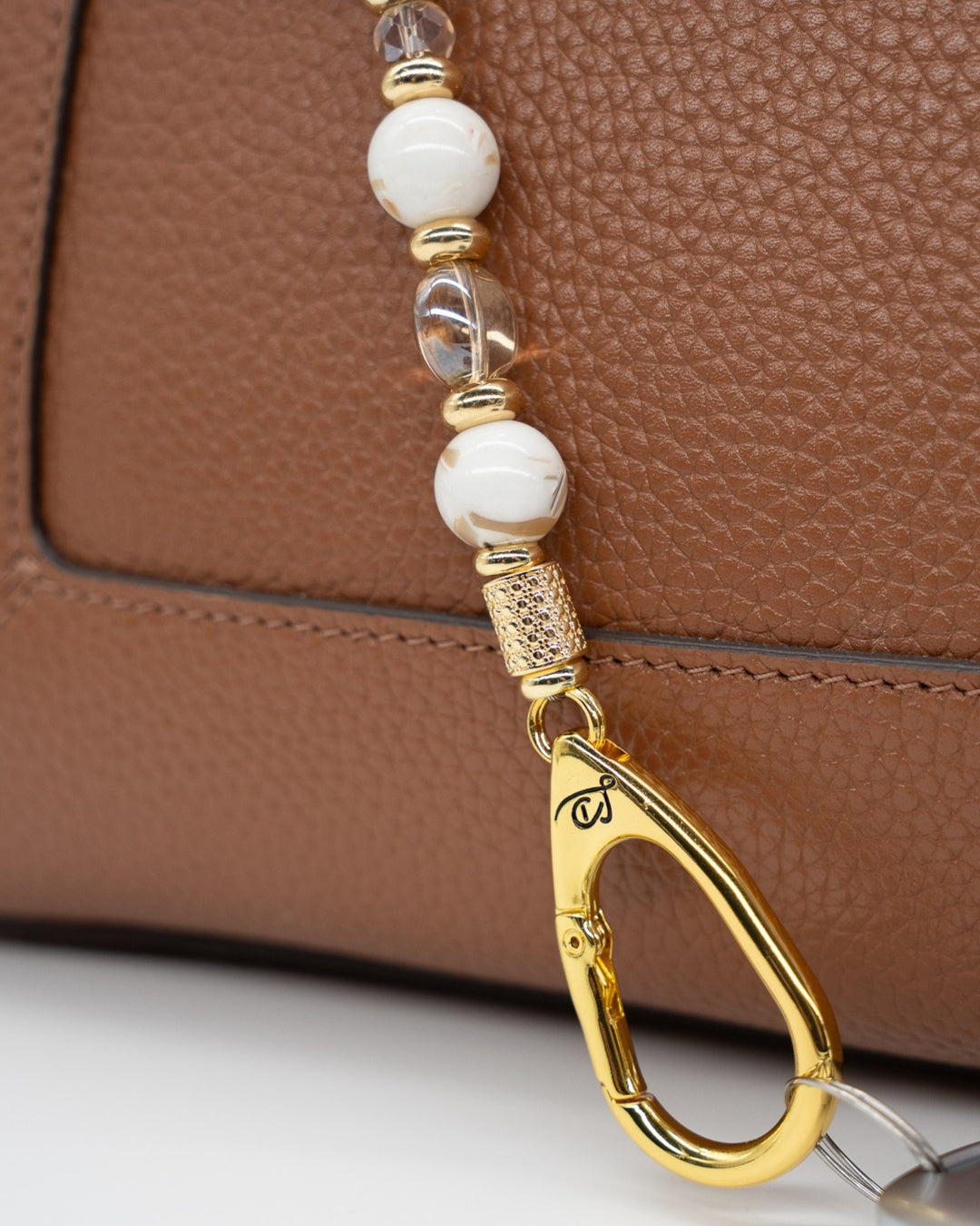 LD Keyfinder Mediterranean Glow beaded keychain with Mother of Pearl, ivory shells, and 18KT gold-plated accents.