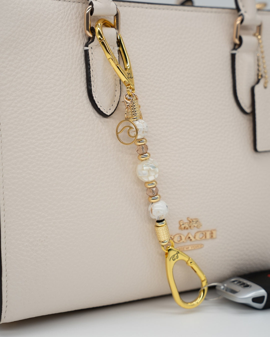 LD Keyfinder Mediterranean Glow-Mini featuring Mother of Pearl, ivory shell beads, gold accents, and ocean charms.