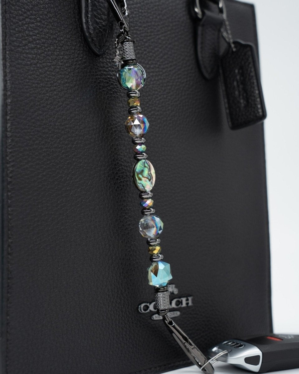 LD Keyfinder Midnight Aurora beaded bag charm with abalone shell, rainbow crystal beads, and moon and star charms.