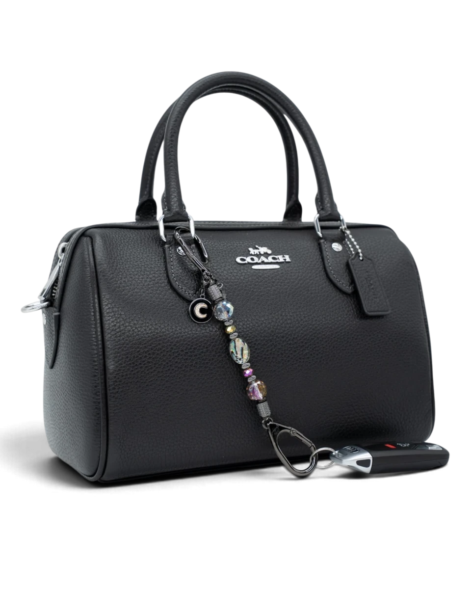 LD Keyfinder Midnight Aurora-Mini beaded charm with abalone and rainbow crystals attached to a black leather handbag