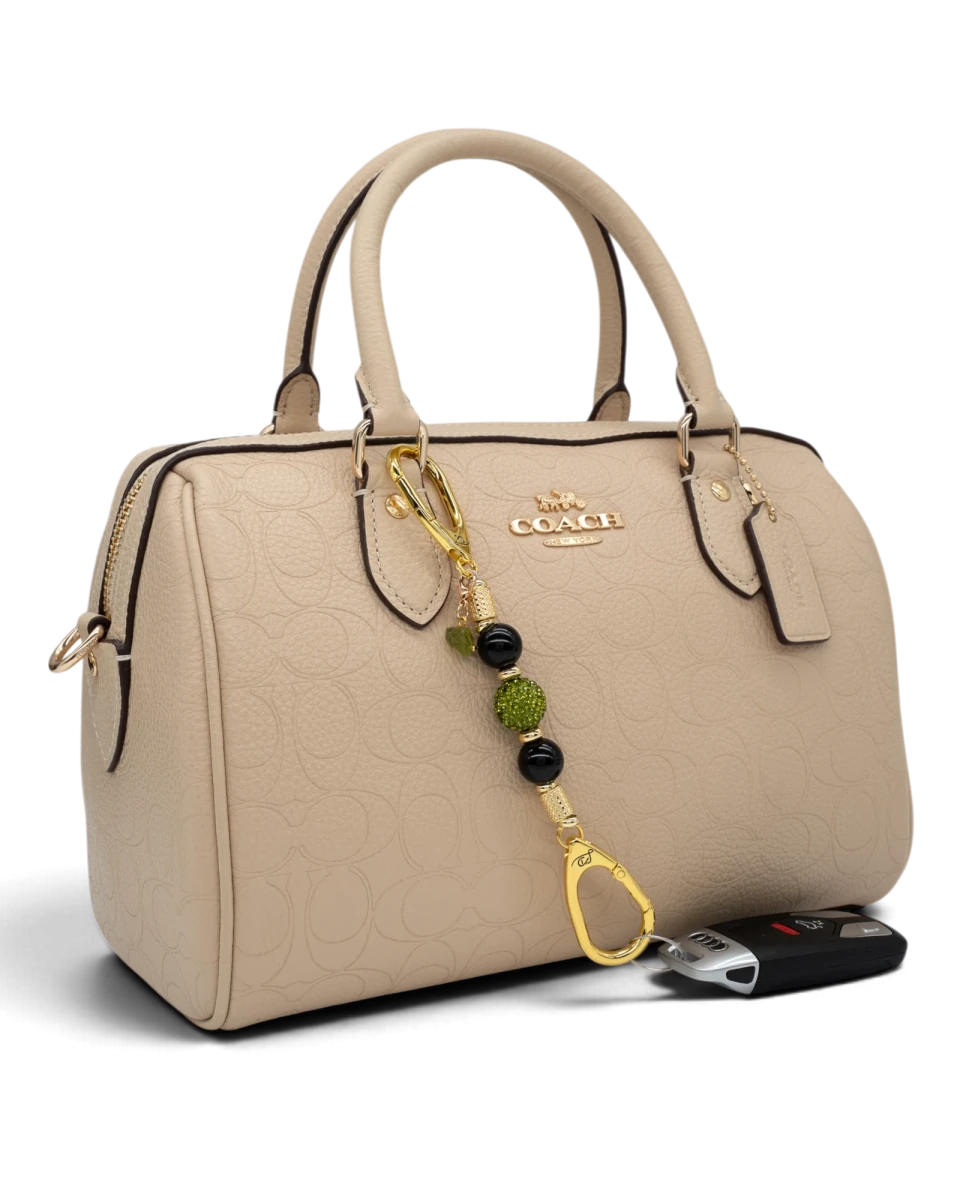 LD Keyfinder Midnight Peridot-Mini keychain with black obsidian and green crystal beads attached to a beige handbag