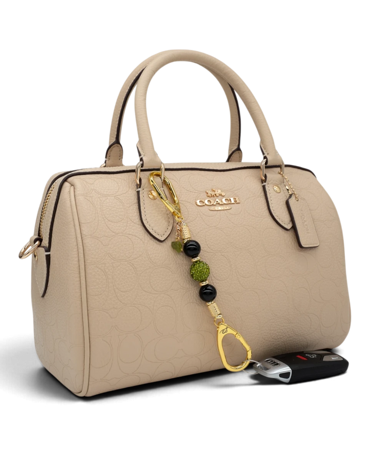 LD Keyfinder Midnight Peridot-Mini keychain with black obsidian and green crystal beads attached to a beige handbag