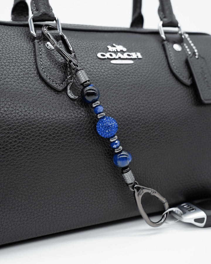 LD Keyfinder Midnight Sapphire Mini beaded keychain with blue tiger eye, sapphire crystals, and a moon charm on a bag