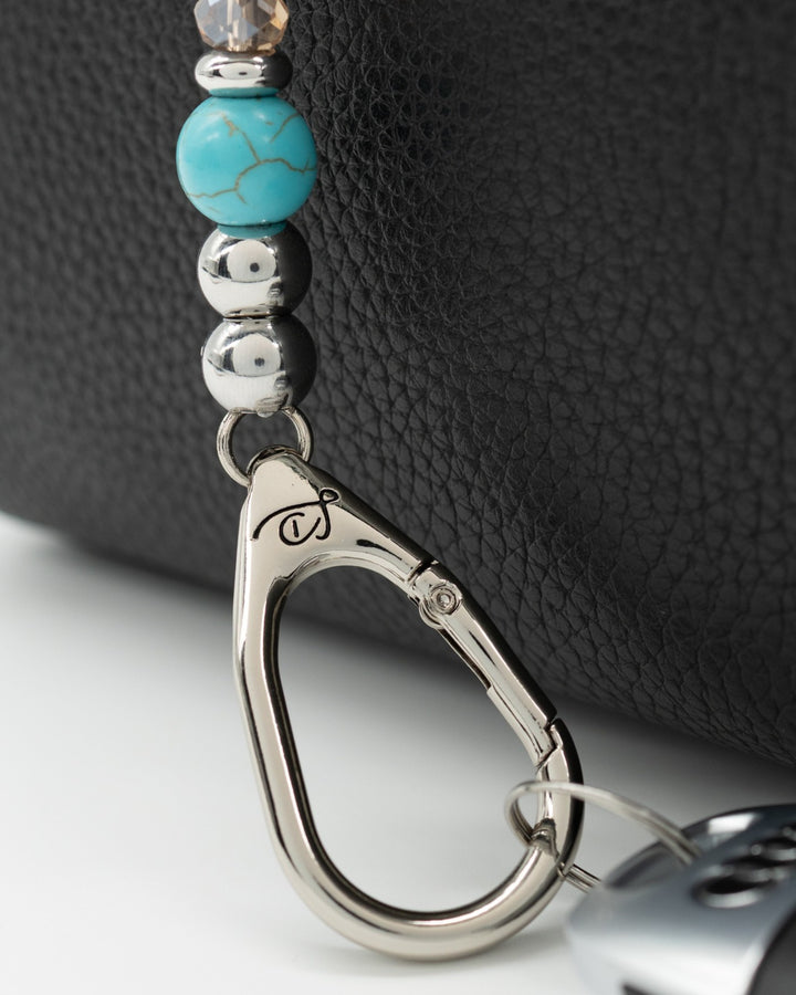 LD Keyfinder Mini Cowgirl Dreams beaded keychain with turquoise, Imperial Jasper, and golden glass beads on a black bag.