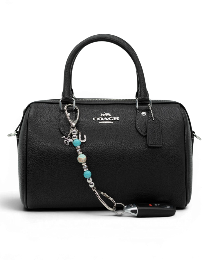 LD Keyfinder Mini Cowgirl Dreams western charm with turquoise, jasper, and horse charms clipped to a black handbag.
