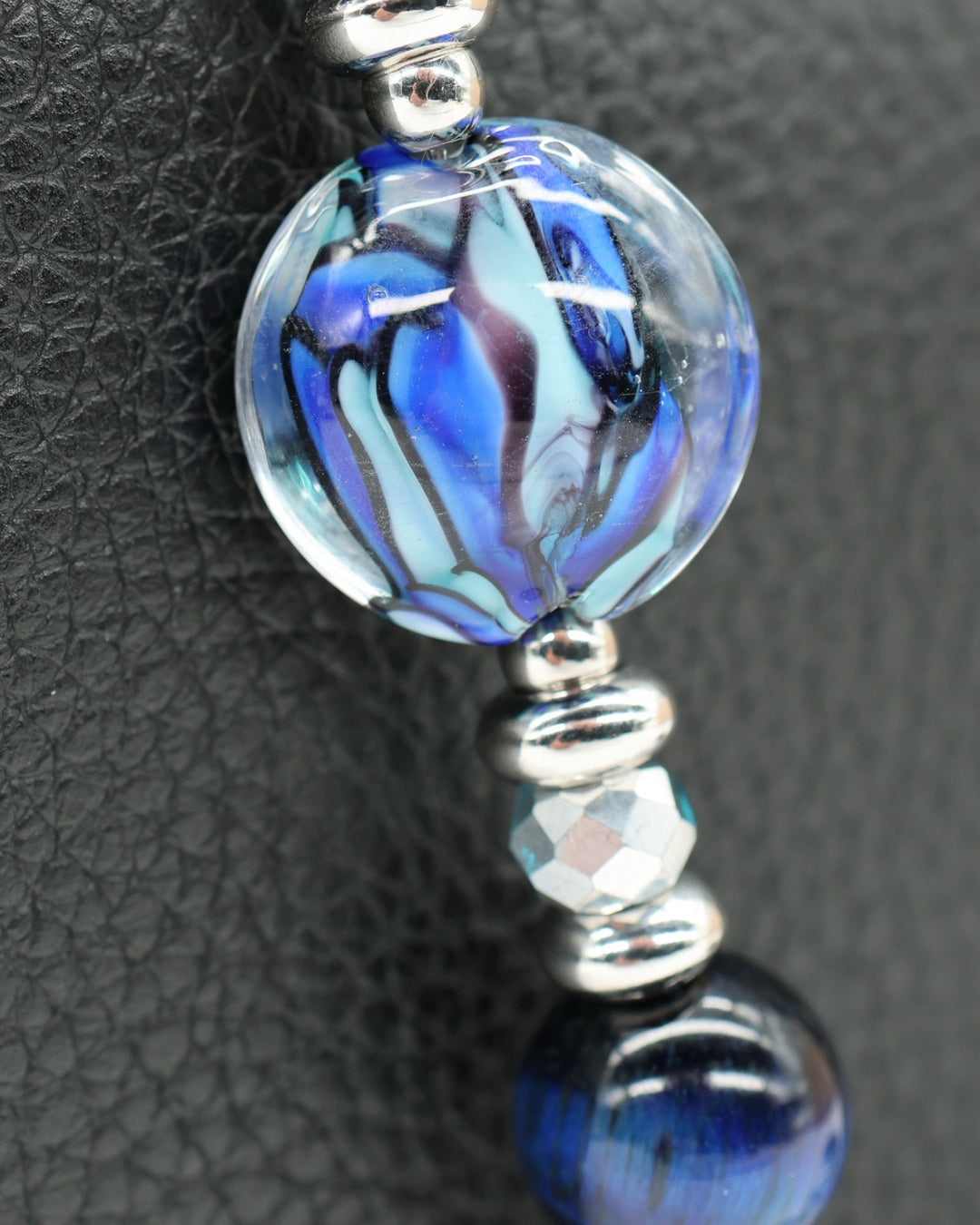 LD Keyfinder Ocean Mosaic Petite featuring a handcrafted blue artisan glass bead, tiger eye, and silver charms.