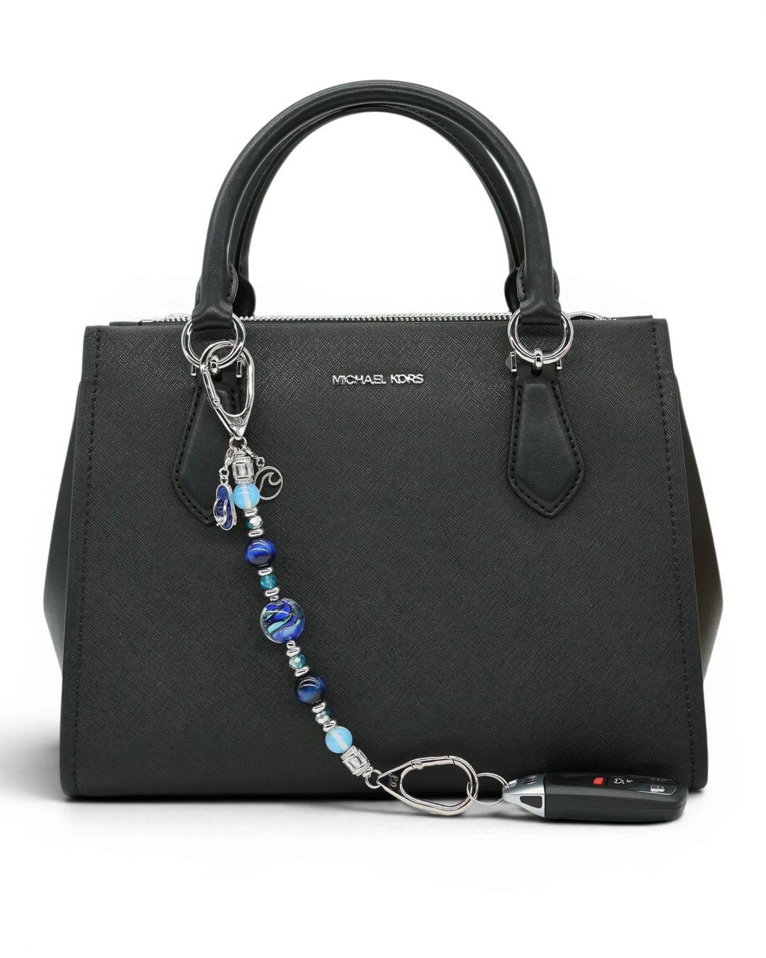 LD Keyfinder Ocean Mosaic beaded accessory with artisan glass, tiger eye, and charms attached to a black handbag
