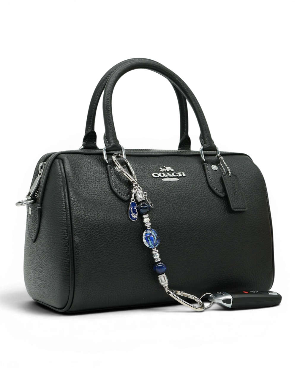 LD Keyfinder Ocean Mosaic Petite attached to a black leather handbag, featuring blue artisan glass and tiger eye beads.