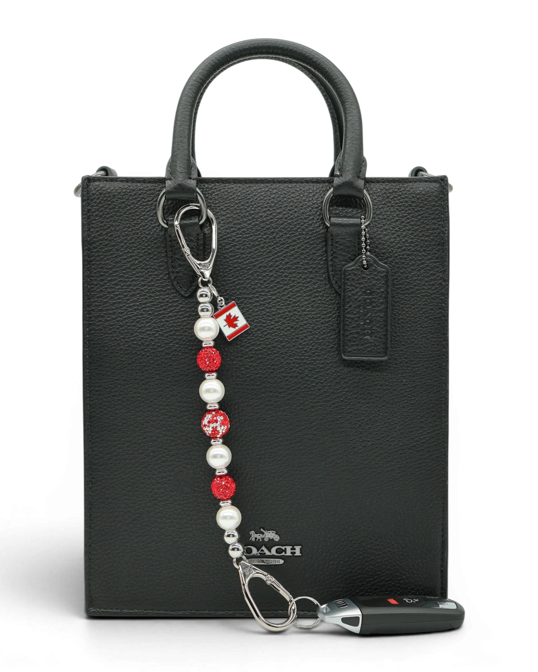 LD Keyfinder Oh Canada Shimmer keychain with red crystal, pearl, and Canada flag charm on black bag.