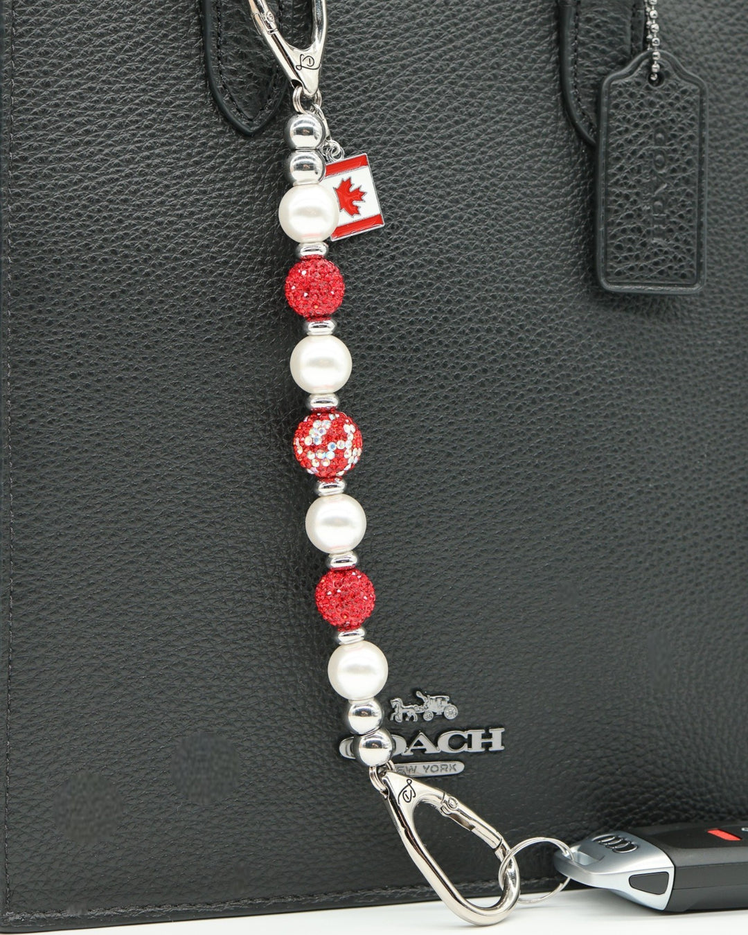 LD Keyfinder Oh Canada Shimmer keychain with red crystal and pearl beads, and a Canada flag charm.