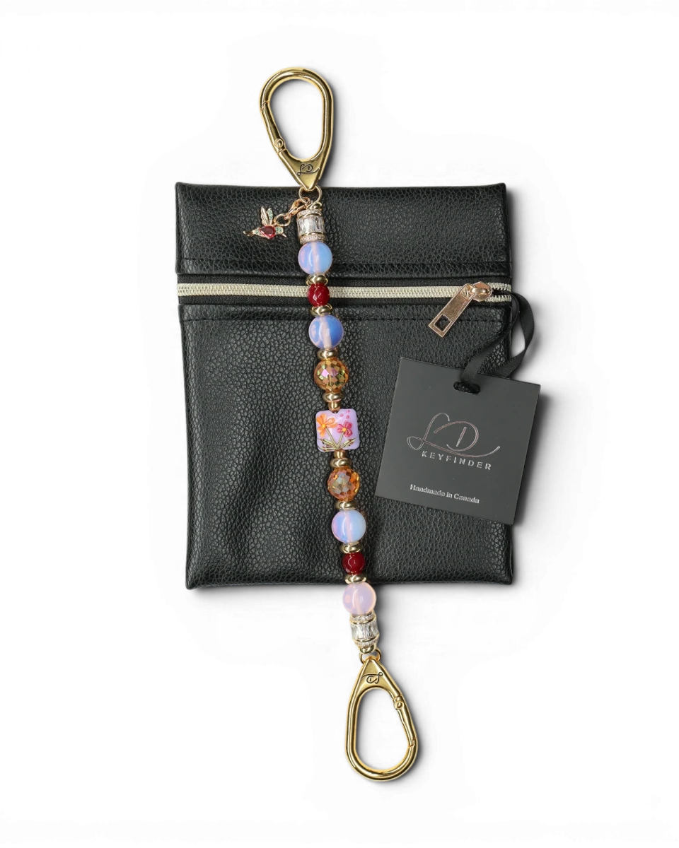 LD Keyfinder Opalite Bloom keychain with pink opalite, ruby red, and burnt orange etched glass beads, featuring a floral lampwork bead and hummingbird charm.