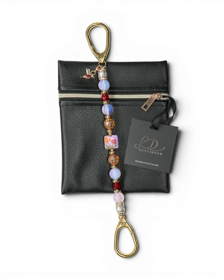 LD Keyfinder Opalite Bloom keychain with pink opalite, ruby red, and burnt orange etched glass beads, featuring a floral lampwork bead and hummingbird charm.