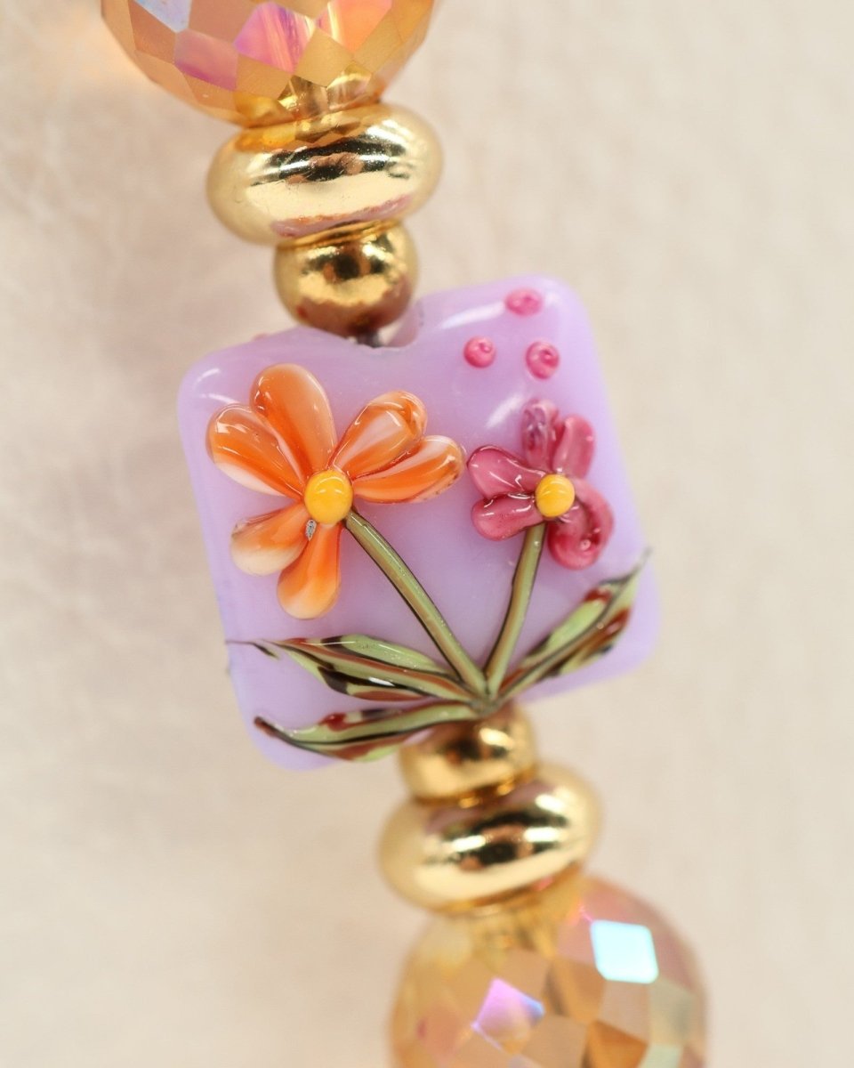 LD Keyfinder Opalite Bloom bracelet with handcrafted lampwork glass bead featuring pink and orange flowers, pink opalite, burnt orange etched glass, ruby, and gold-plated beads.