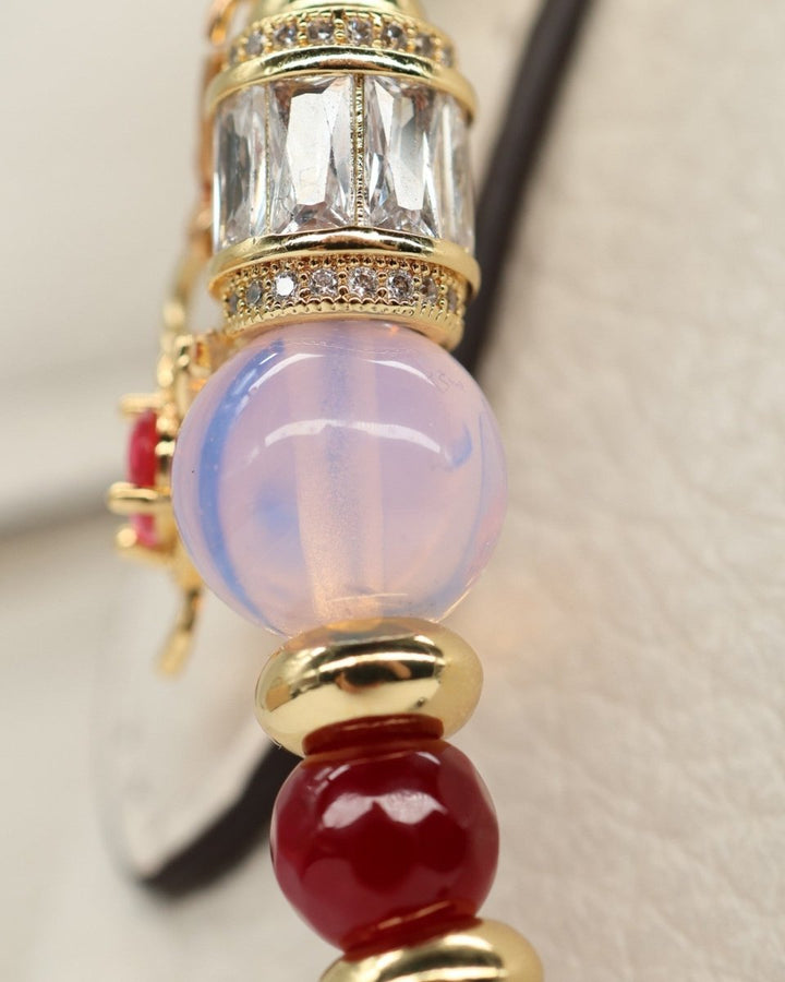 LD Keyfinder Opalite Bloom charm with pink opalite, ruby, and gold beads, and a crystal-encrusted barrel. Features a hummingbird charm.