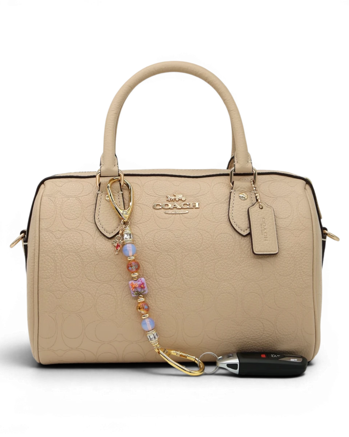LD Keyfinder Petite Opalite Bloom keychain with pink opalite, burnt orange glass beads, and hummingbird charm.