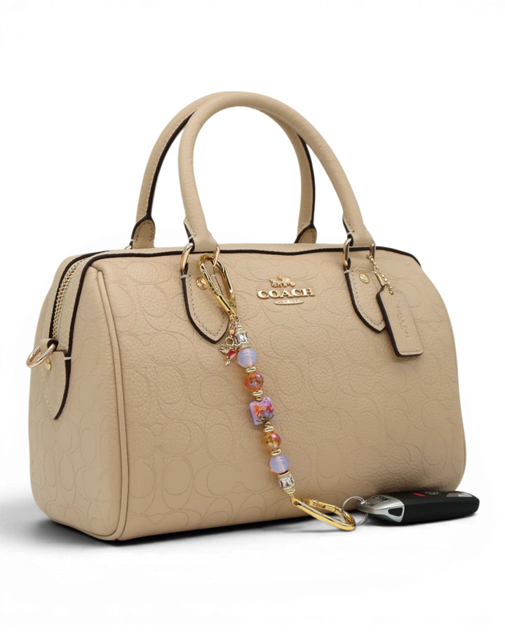 LD Keyfinder Petite Opalite Bloom keychain with pink opalite, burnt orange glass beads, and hummingbird charm.