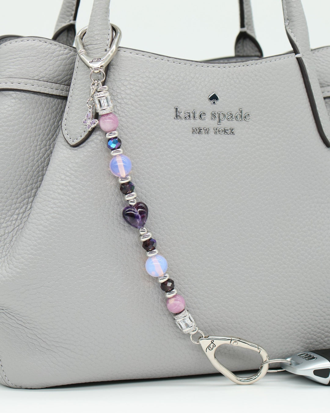 LD Keyfinder Orchid Flutter beaded accessory with lepidolite, opalite, and glass beads, featuring a butterfly charm.