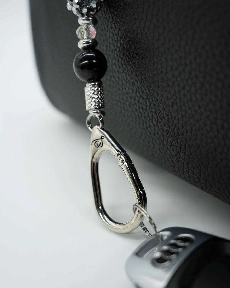 LD Keyfinder Owl That Glitters Mini featuring black obsidian, iridescent glass, and a sparkling owl charm on a bag.