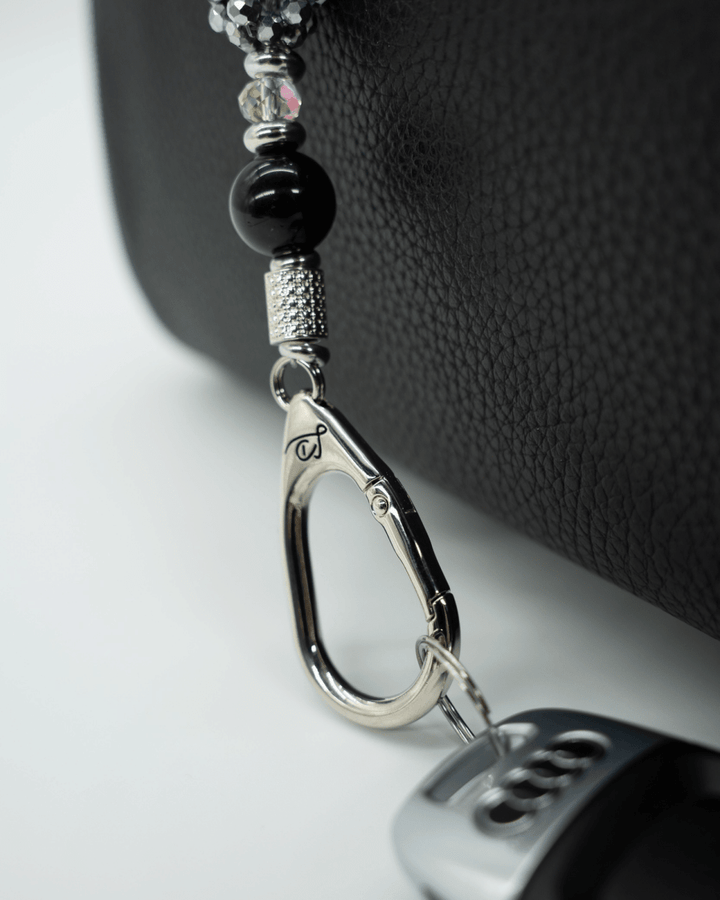 LD Keyfinder Owl That Glitters Mini featuring black obsidian, iridescent glass, and a sparkling owl charm on a bag.
