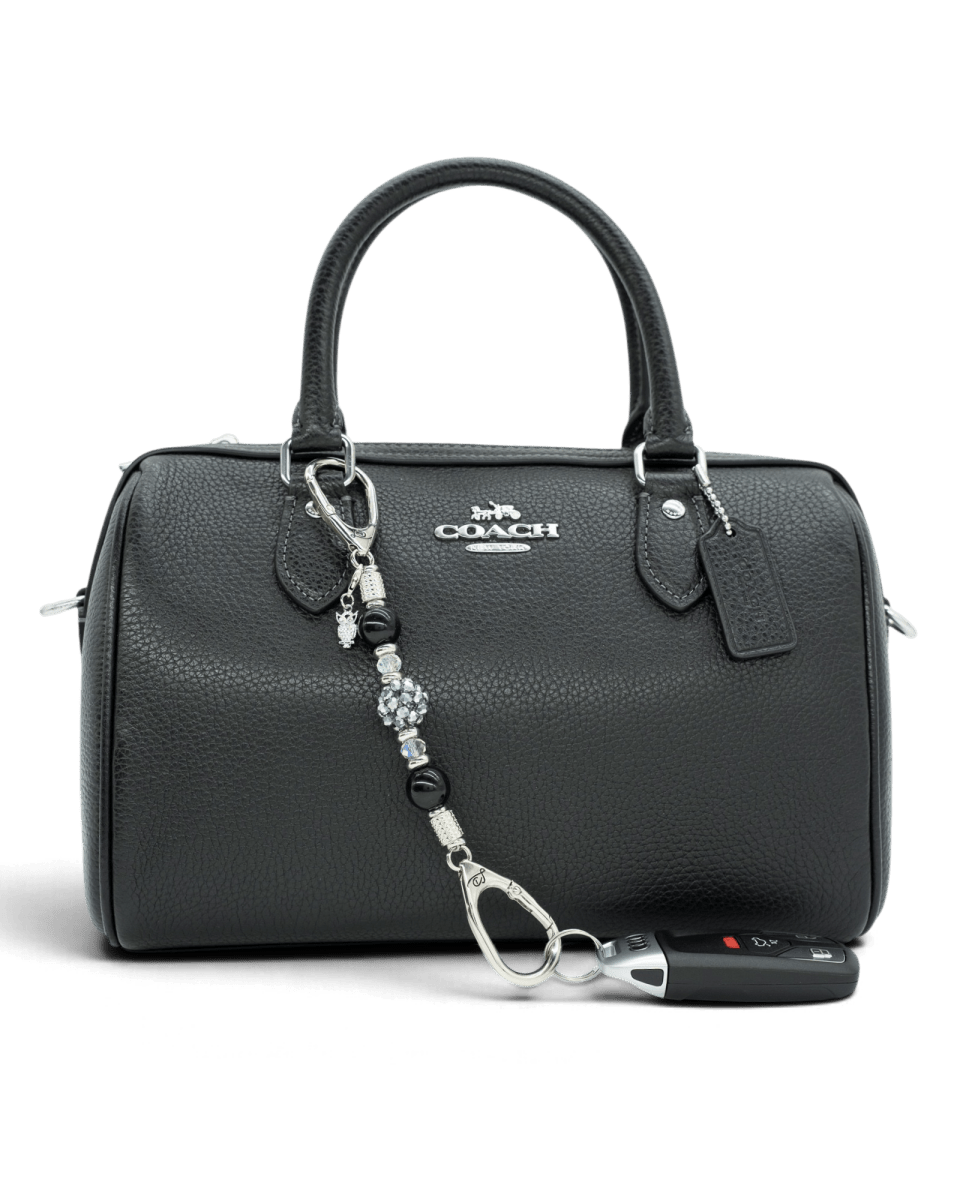 LD Keyfinder Owl That Glitters Mini featuring black obsidian, iridescent glass, and a sparkling owl charm on a handbag