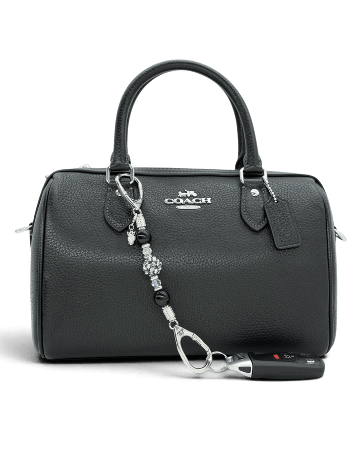 LD Keyfinder Owl That Glitters Mini featuring black obsidian, iridescent glass, and a sparkling owl charm on a handbag